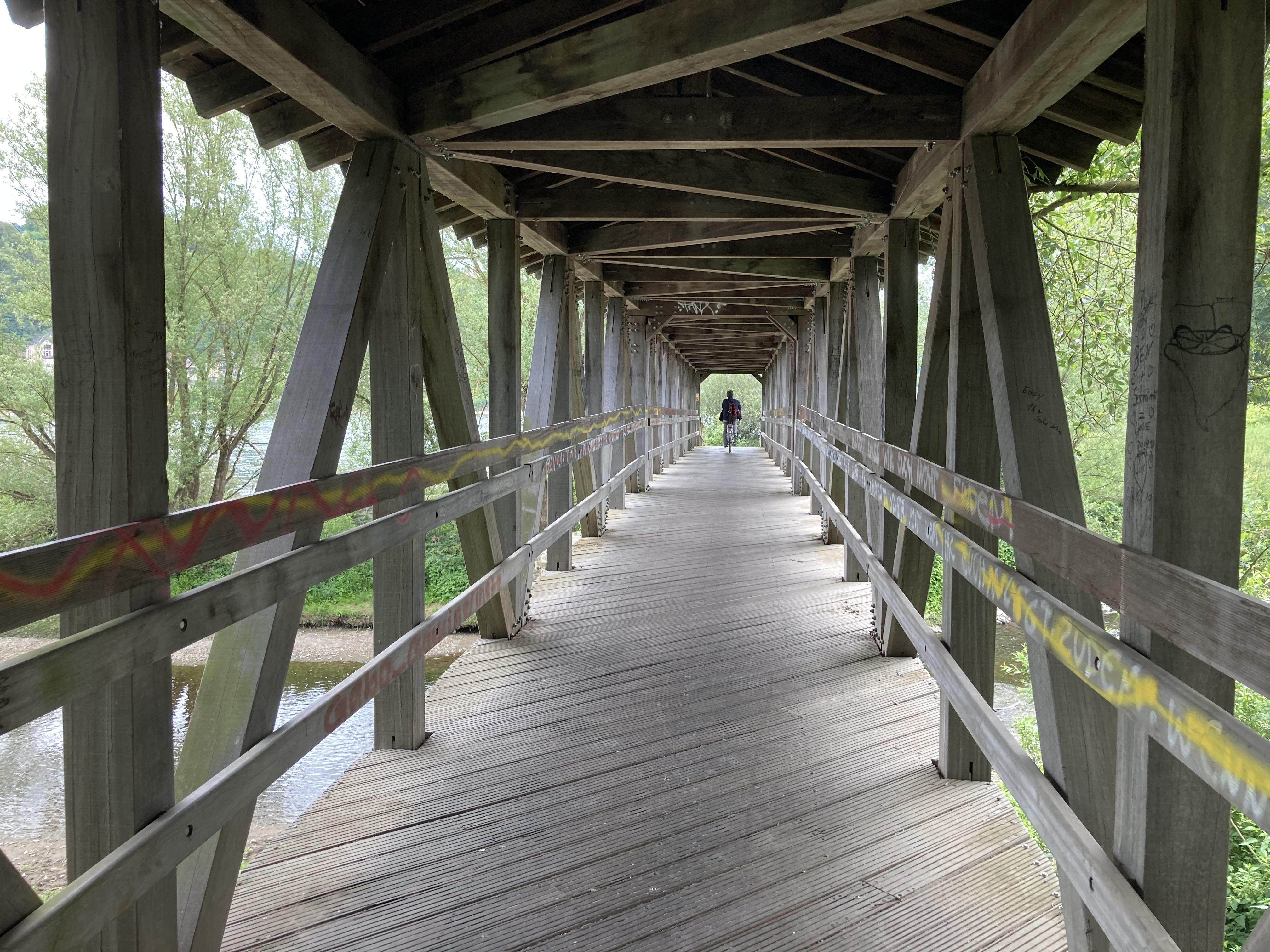 View looking down a covered wooden bridge