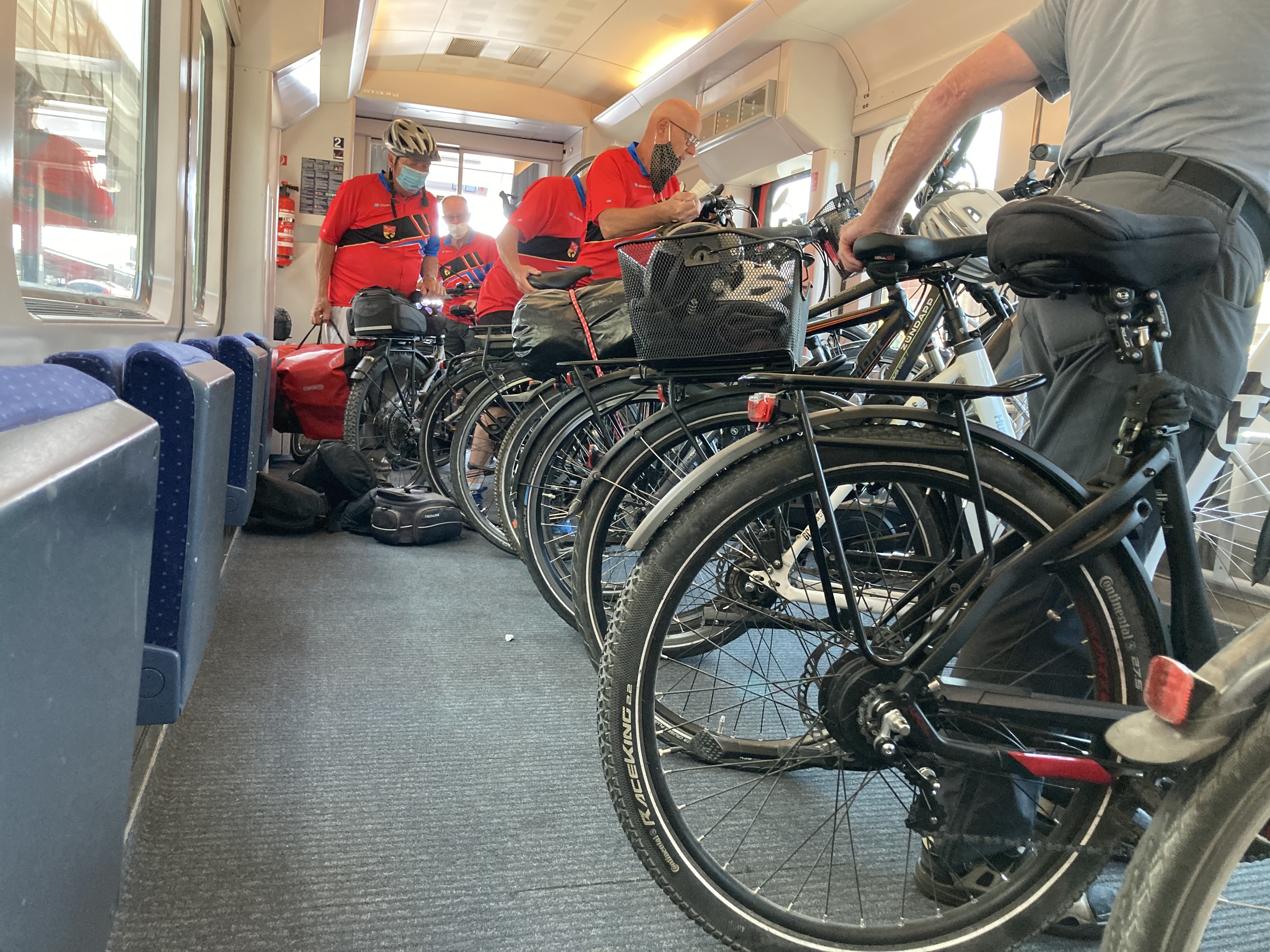 Confused German retirees boarding a train with ebikes